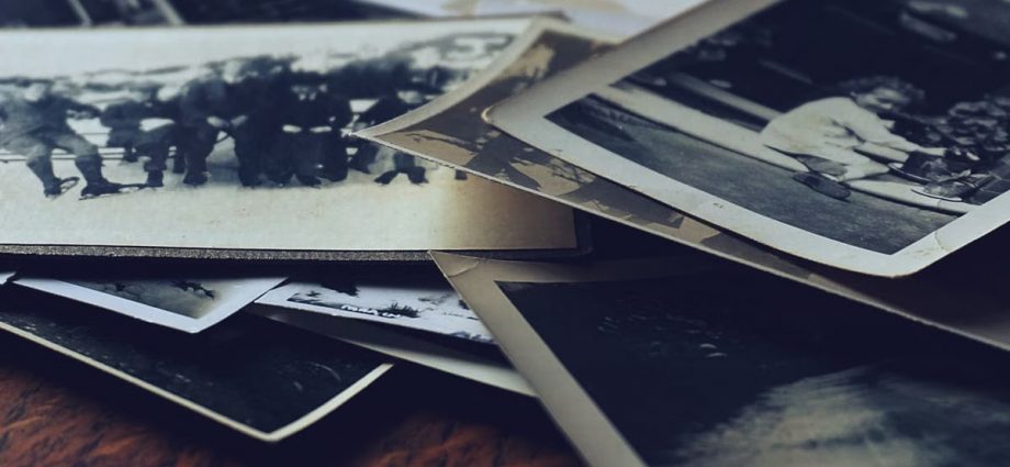 A stack of classic black and white photographs showcasing family memories and history.